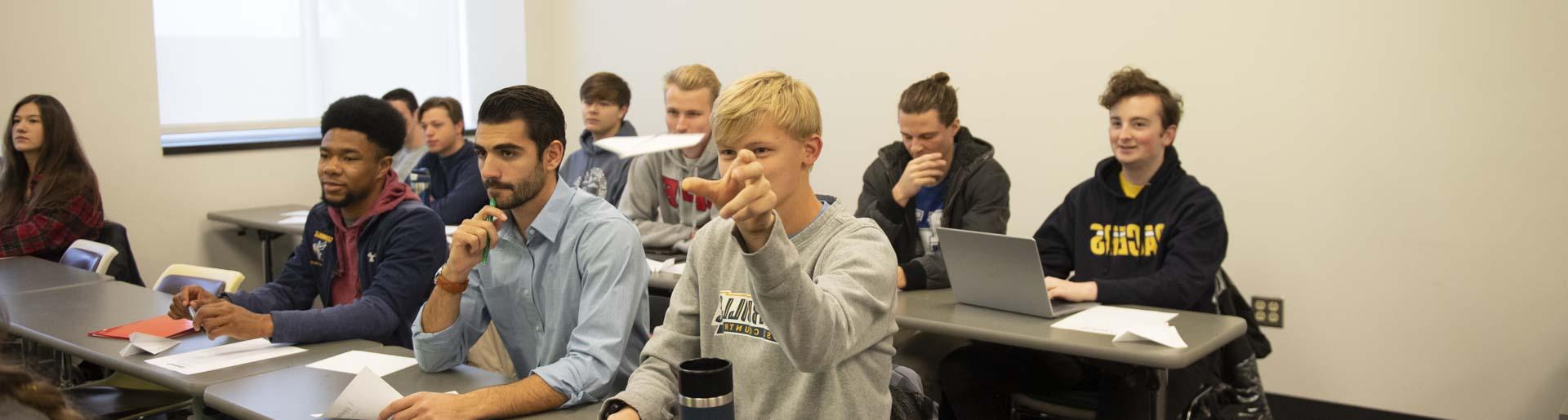 Students throwing paper airplanes in class