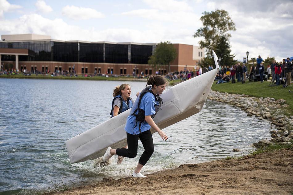 Canoe #28 attempts to make it to shore as spectators watch on.