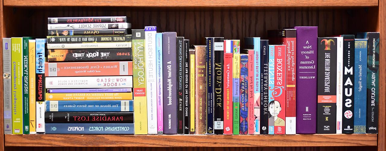 A bookshelf full of a random assortment of books.