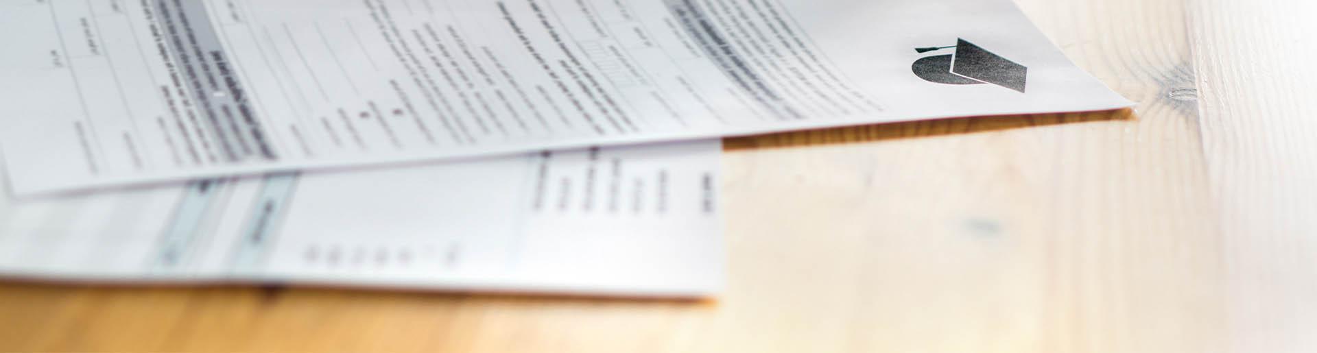 School transcript documents on a desk.