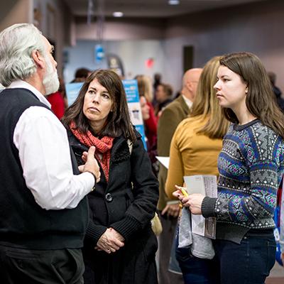 Parent and student talking to a professor