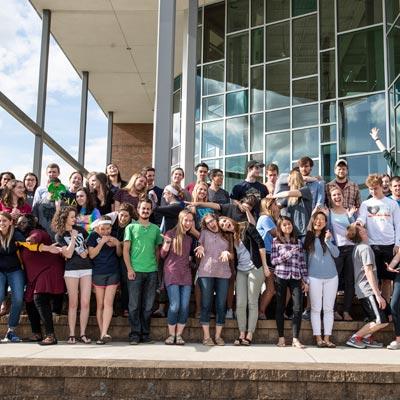 picture of students outside of the BTS waving and smiling